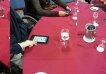 People with tablets around a table