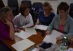 four women reviewing documentation