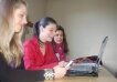 Girls learning together in front of a computer